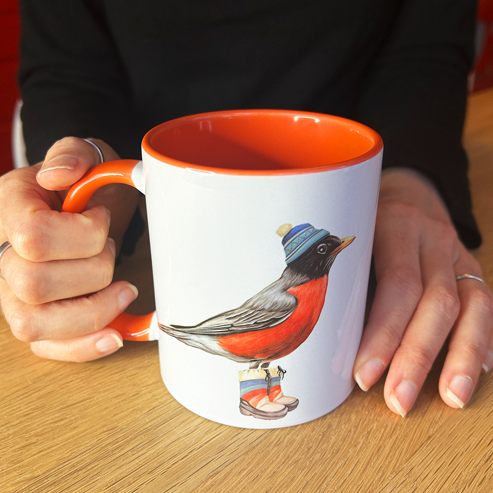 American Robin mug with orange accents in hands view