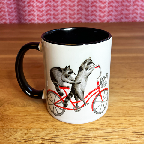 Raccoons riding a Bike Mug